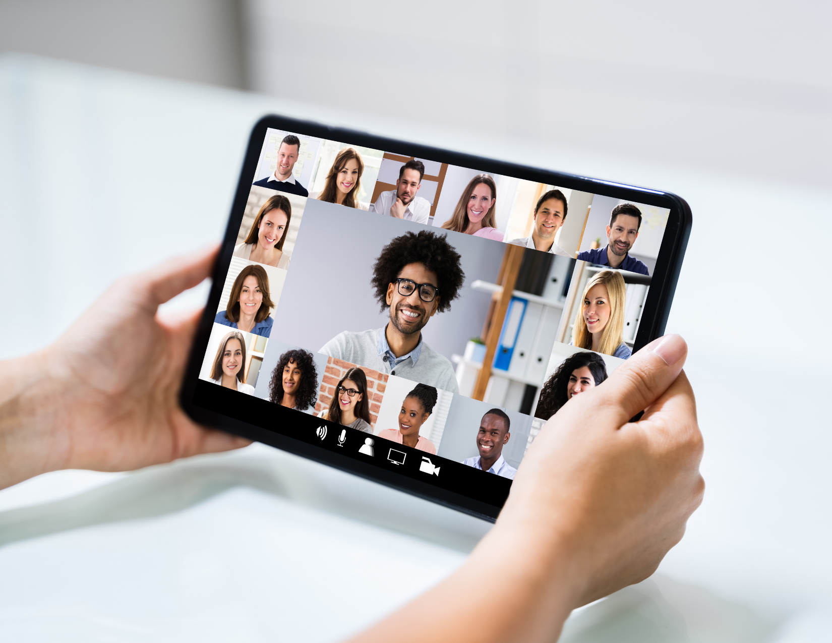 MAny different faces are in boxes on a tablet screen for a webinar